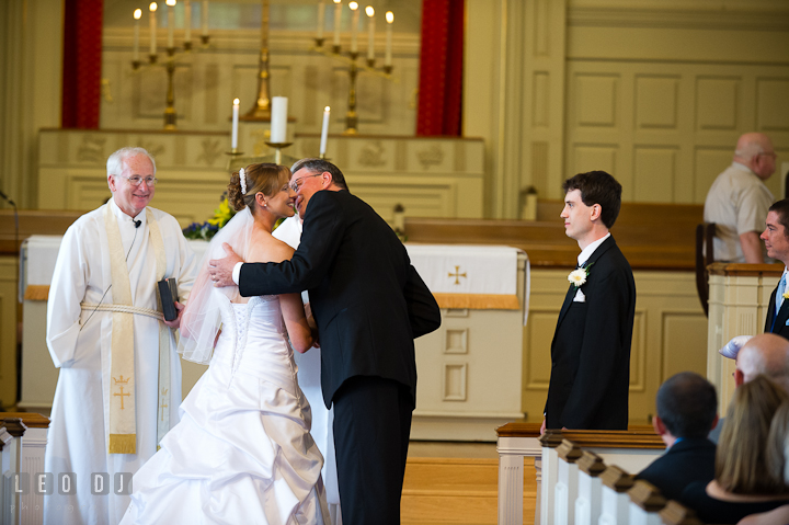 Father kissed bride as he gave her daughter away. St. Mark United Methodist Church wedding photos at Easton, Eastern Shore, Maryland by photographers of Leo Dj Photography. http://leodjphoto.com