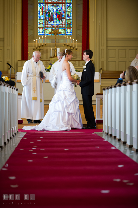 Bride and Groom holding hands, receiving prayers from the pastors. St. Mark United Methodist Church wedding photos at Easton, Eastern Shore, Maryland by photographers of Leo Dj Photography. http://leodjphoto.com