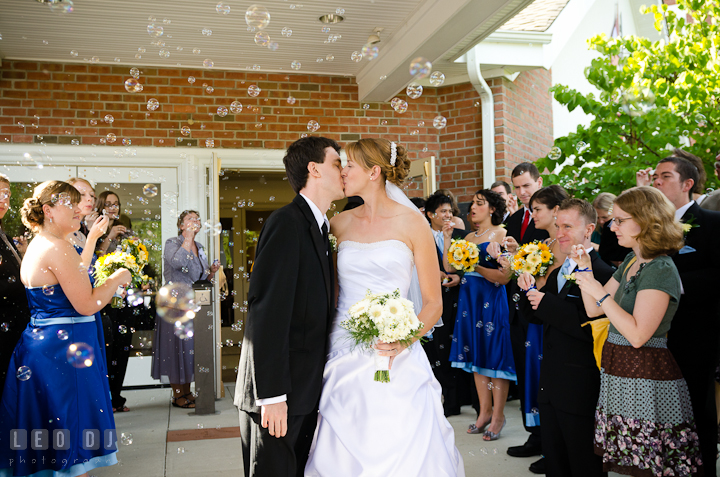 Bride and Groom kissing while guest are blowing bubbles. St. Mark United Methodist Church wedding photos at Easton, Eastern Shore, Maryland by photographers of Leo Dj Photography. http://leodjphoto.com