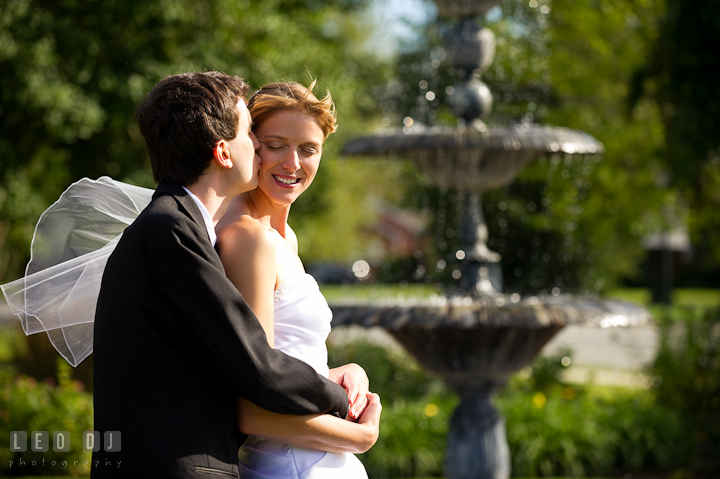 Groom kissed Bride near a water fountain. St. Mark United Methodist Church wedding photos at Easton, Eastern Shore, Maryland by photographers of Leo Dj Photography. http://leodjphoto.com