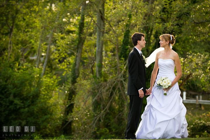 Bride and Groom holding hands and looking at each other. Riverhouse Pavilion wedding photos at Easton, Eastern Shore, Maryland by photographers of Leo Dj Photography. http://leodjphoto.com