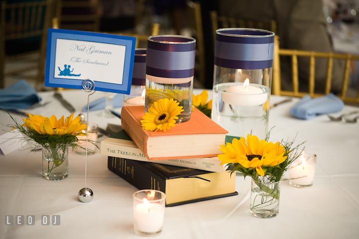 Table centerpiece decoration using books, candles, and flowers. Riverhouse Pavilion wedding photos at Easton, Eastern Shore, Maryland by photographers of Leo Dj Photography. http://leodjphoto.com