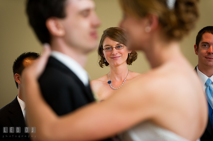 Maid of Honor and Bride's sister looking at the Bride and Groom's first dance. Riverhouse Pavilion wedding photos at Easton, Eastern Shore, Maryland by photographers of Leo Dj Photography. http://leodjphoto.com