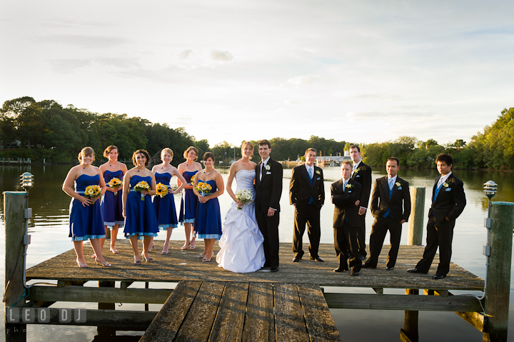 Bride and Groom posing with the wedding party at the boat pier. Riverhouse Pavilion wedding photos at Easton, Eastern Shore, Maryland by photographers of Leo Dj Photography. http://leodjphoto.com