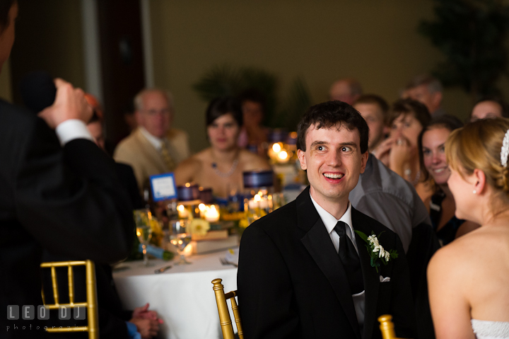 Groom laughing listening to Best Man's speech. Riverhouse Pavilion wedding photos at Easton, Eastern Shore, Maryland by photographers of Leo Dj Photography. http://leodjphoto.com