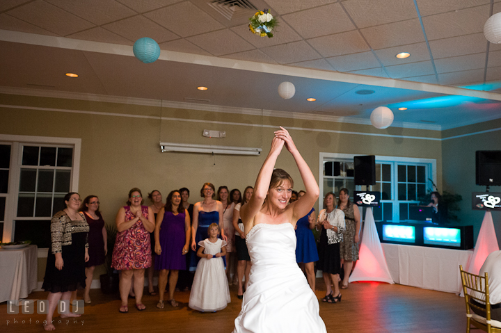 Bride tossing the bouquet to the single ladies. Riverhouse Pavilion wedding photos at Easton, Eastern Shore, Maryland by photographers of Leo Dj Photography. http://leodjphoto.com