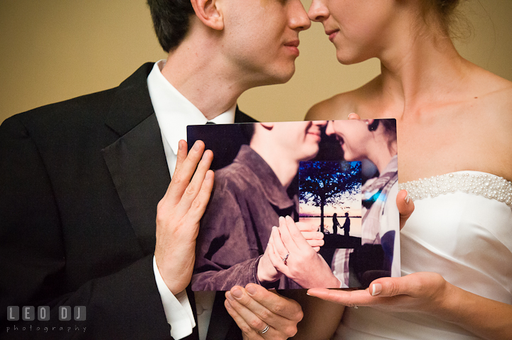 Bride and Groom holding a photo of their engagement session holding a photo of their first date. Riverhouse Pavilion wedding photos at Easton, Eastern Shore, Maryland by photographers of Leo Dj Photography. http://leodjphoto.com