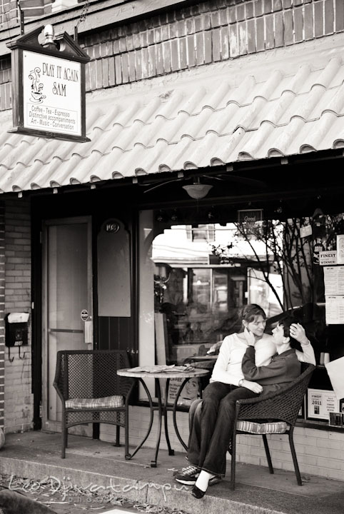 Engaged couple cuddling in front of Play It Again Sam coffee shop. Pre-wedding engagement photo session at Washington College and Chestertown, Maryland, by wedding photographer Leo Dj Photography.