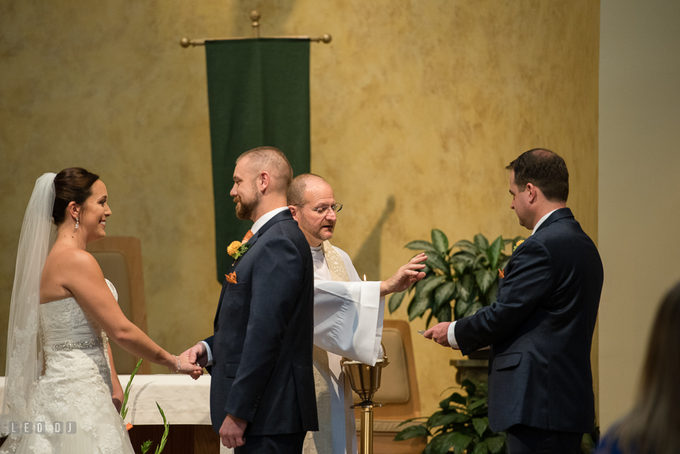 St Andrew by the Bay wedding ceremony priest blessing rings photo by Leo Dj Photography.