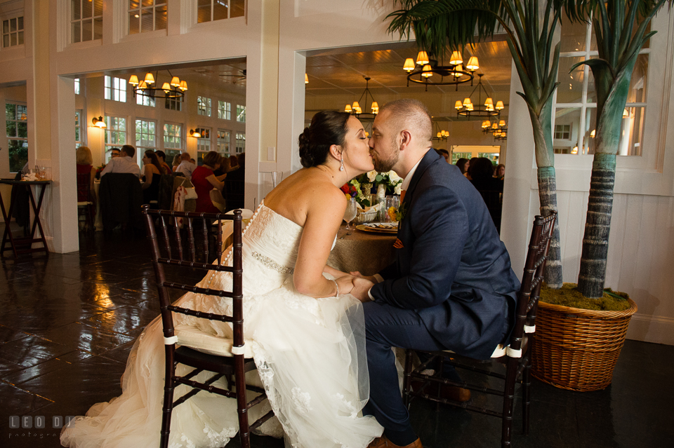 Chesapeake Bay Beach Club Bride and Groom kissing by sweetheart table photo by Leo Dj Photography.