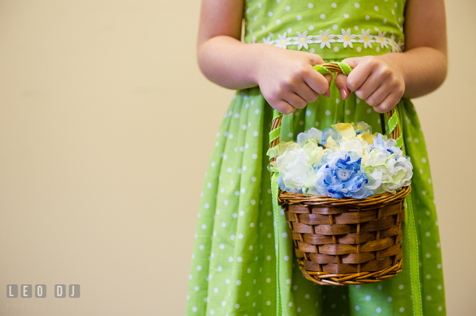 Flower girl holding a basket of fabric flower petals. Fisherman's Inn, Safe Harbor Church, Kent Island, Eastern Shore Maryland, wedding reception and ceremony photo, by wedding photographers of Leo Dj Photography. http://leodjphoto.com