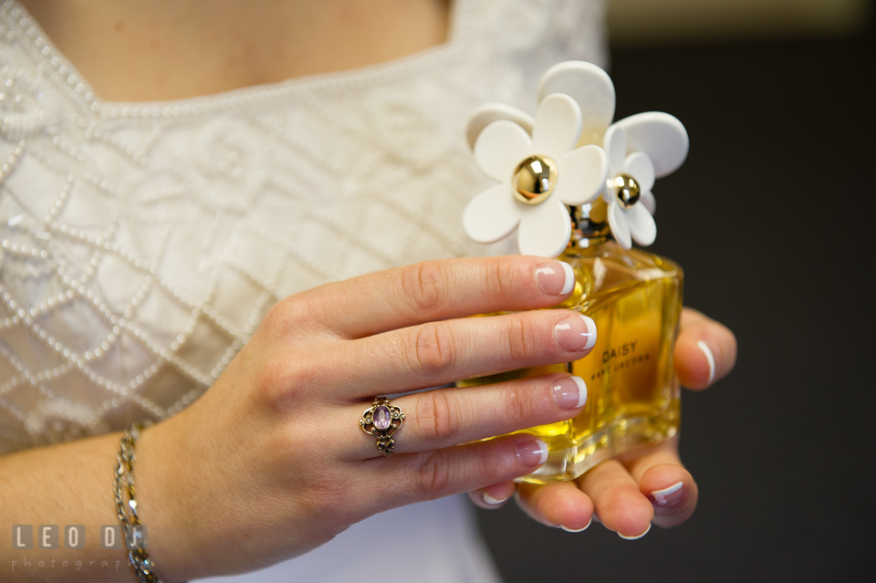 Bride holding bottle of perfume, Daisy by Marc Jacobs. Fisherman's Inn, Safe Harbor Church, Kent Island, Eastern Shore Maryland, wedding reception and ceremony photo, by wedding photographers of Leo Dj Photography. http://leodjphoto.com