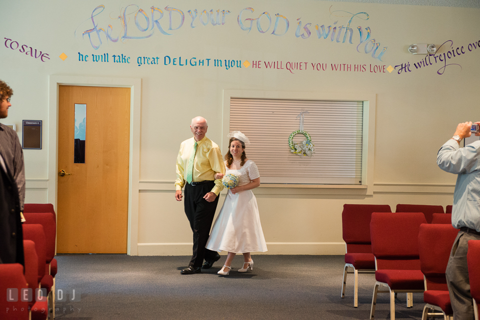 Father of the Bride escorting daughter walking down the aisle during processional. Fisherman's Inn, Safe Harbor Church, Kent Island, Eastern Shore Maryland, wedding reception and ceremony photo, by wedding photographers of Leo Dj Photography. http://leodjphoto.com