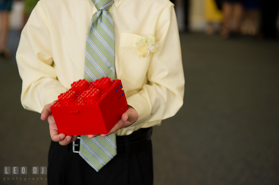 Ring bearer boy holding ring box made out of LEGO. Fisherman's Inn, Safe Harbor Church, Kent Island, Eastern Shore Maryland, wedding reception and ceremony photo, by wedding photographers of Leo Dj Photography. http://leodjphoto.com