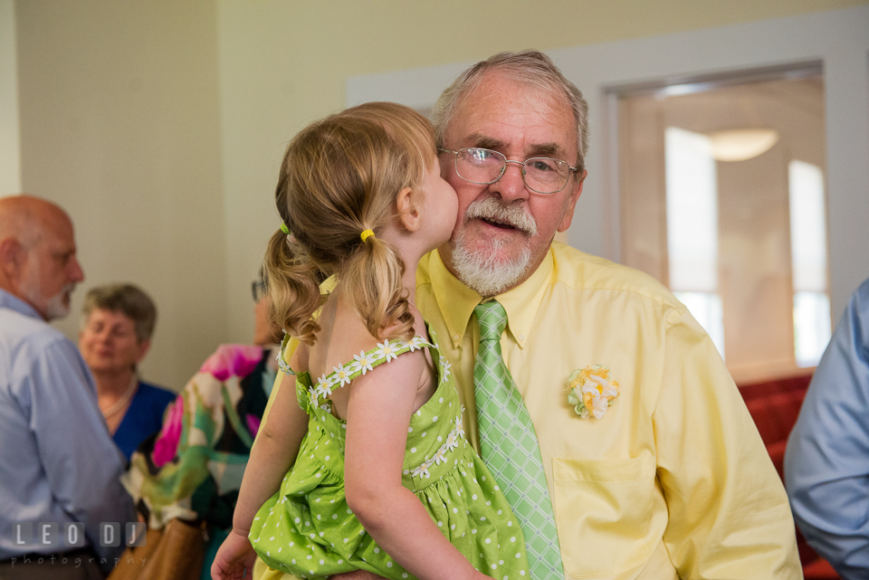 Flower girl kissing her Grandfather, the Father of the Groom. Fisherman's Inn, Safe Harbor Church, Kent Island, Eastern Shore Maryland, wedding reception and ceremony photo, by wedding photographers of Leo Dj Photography. http://leodjphoto.com