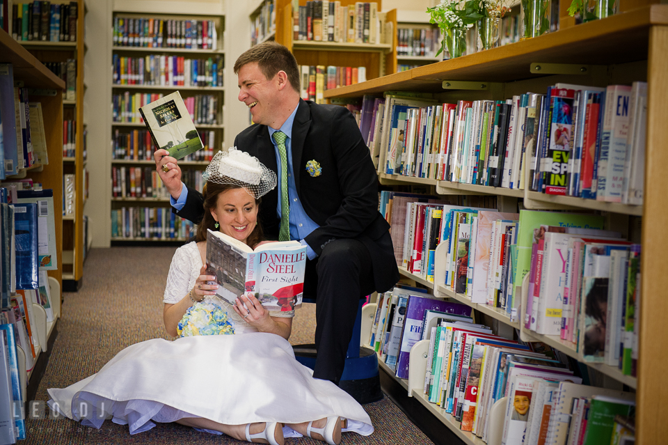 Bride and Groom sitting and reading books together in the library. Fisherman's Inn, Safe Harbor Church, Kent Island, Eastern Shore Maryland, wedding reception and ceremony photo, by wedding photographers of Leo Dj Photography. http://leodjphoto.com