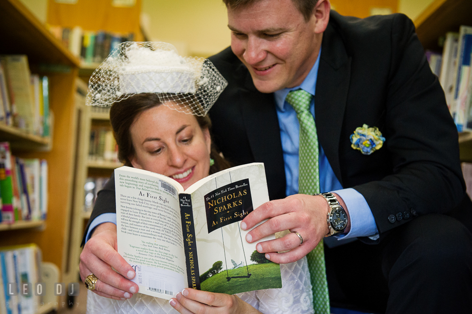 Bride and Groom reading a book and smiling. Fisherman's Inn, Safe Harbor Church, Kent Island, Eastern Shore Maryland, wedding reception and ceremony photo, by wedding photographers of Leo Dj Photography. http://leodjphoto.com