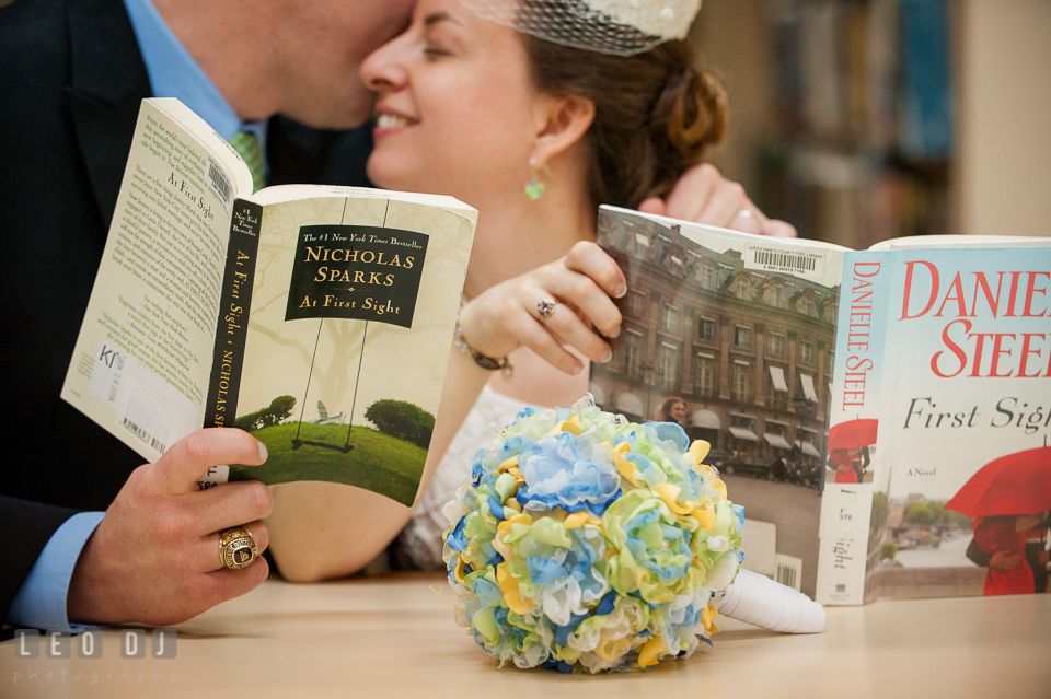 Groom kissed Bride while reading books together in the library. Fisherman's Inn, Safe Harbor Church, Kent Island, Eastern Shore Maryland, wedding reception and ceremony photo, by wedding photographers of Leo Dj Photography. http://leodjphoto.com