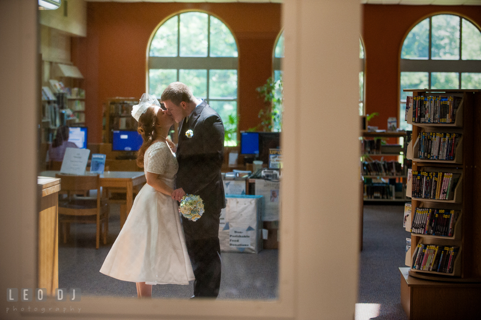 Bride and Groom kissing in the library. Fisherman's Inn, Safe Harbor Church, Kent Island, Eastern Shore Maryland, wedding reception and ceremony photo, by wedding photographers of Leo Dj Photography. http://leodjphoto.com