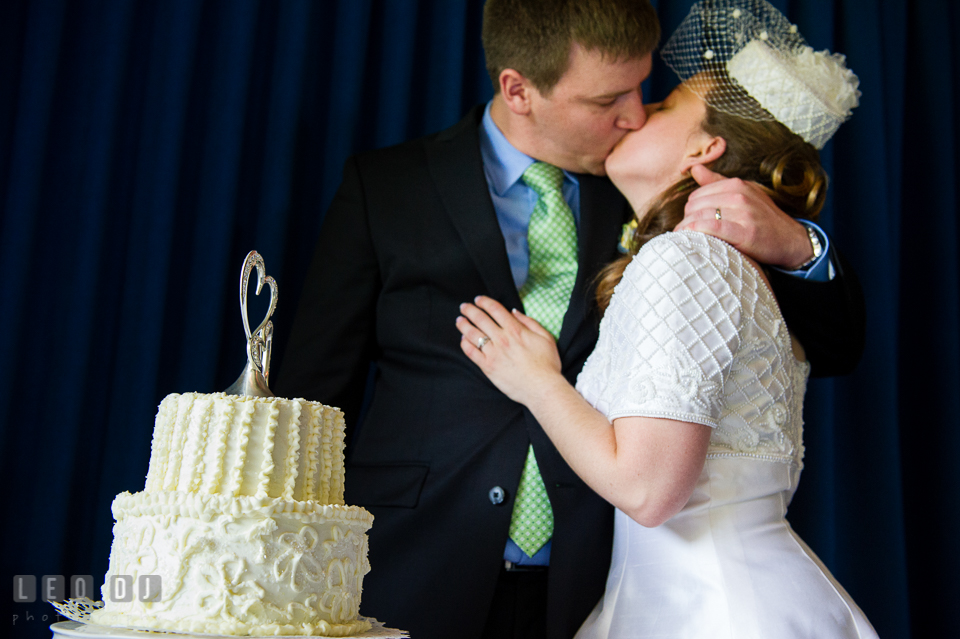 Bride and Groom kissing after the wedding cake cutting. Fisherman's Inn, Safe Harbor Church, Kent Island, Eastern Shore Maryland, wedding reception and ceremony photo, by wedding photographers of Leo Dj Photography. http://leodjphoto.com