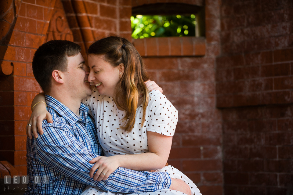 Engaged girl lauging and cuddling with her fiancé. Washington DC pre-wedding engagement photo session at the Capitol Hill and the Mall, by wedding photographers of Leo Dj Photography. http://leodjphoto.com