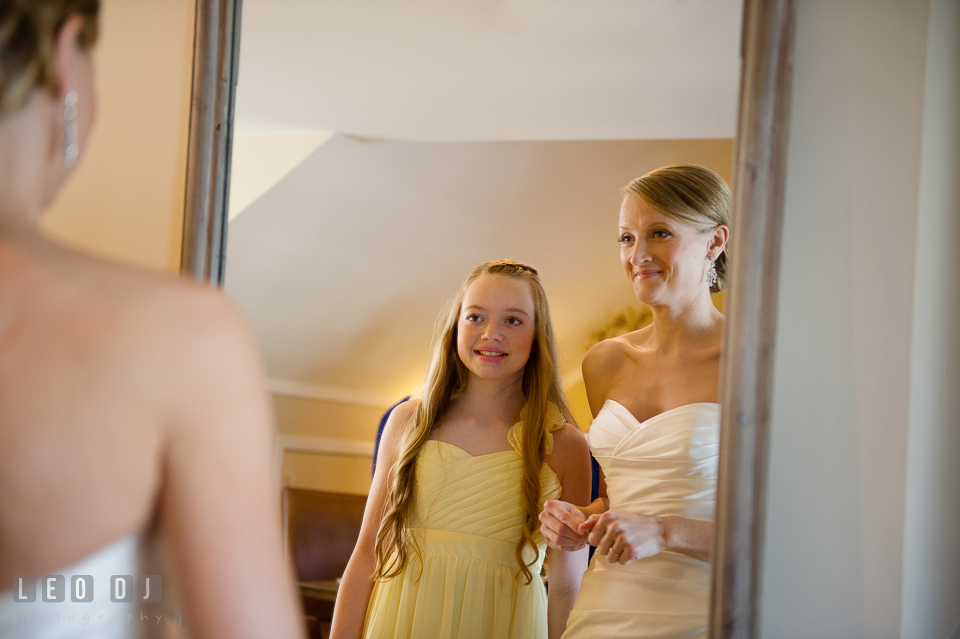 Bride and her niece looking at the mirror and smiling. Kent Island Maryland Chesapeake Bay Beach Club wedding photo, by wedding photographers of Leo Dj Photography. http://leodjphoto.com