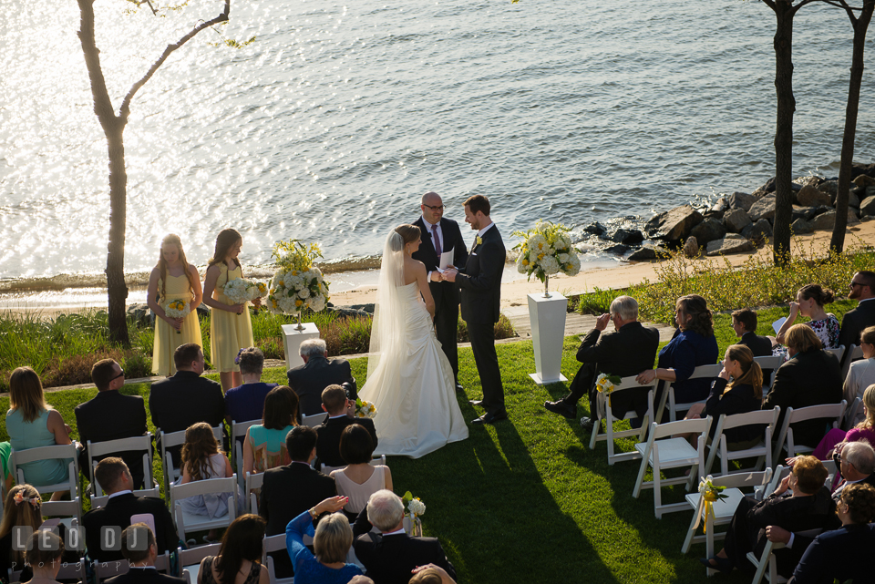 A bird's eye view of the Bride and Groom during the ceremony with water in the background. Kent Island Maryland Chesapeake Bay Beach Club wedding photo, by wedding photographers of Leo Dj Photography. http://leodjphoto.com