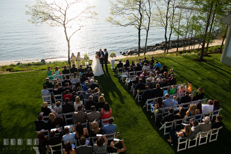 A view from above of the ceremony site with the beach and water in the background. Kent Island Maryland Chesapeake Bay Beach Club wedding photo, by wedding photographers of Leo Dj Photography. http://leodjphoto.com