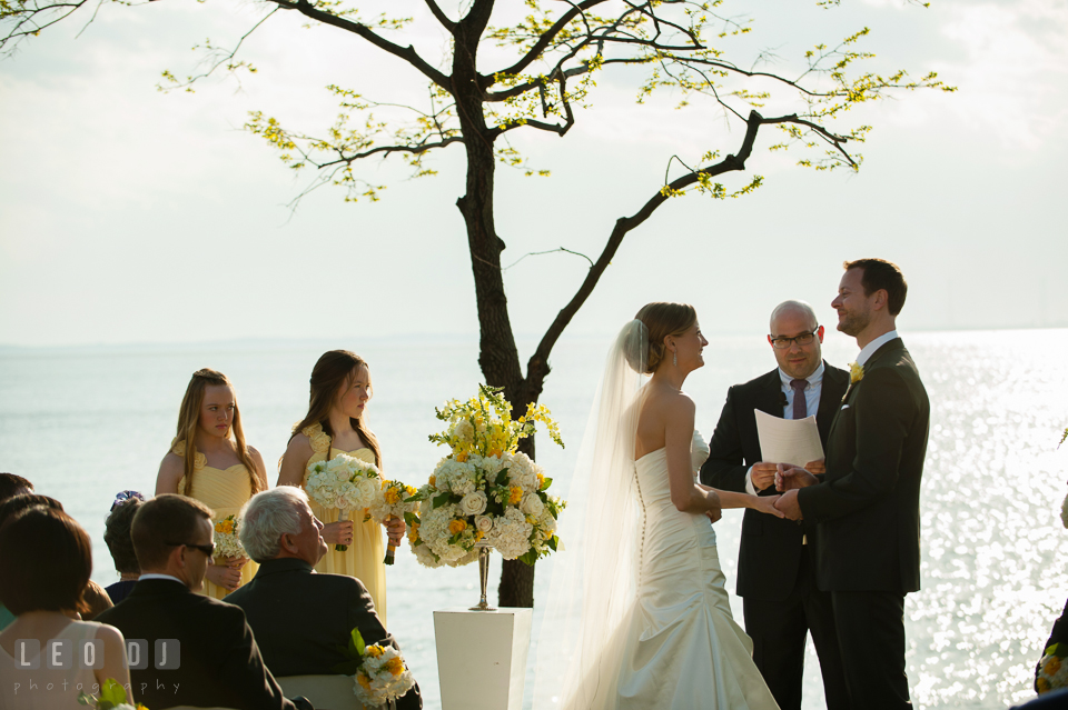 Bride and Groom looking at each other during the ceremony watched by their junior bridesmaids. Kent Island Maryland Chesapeake Bay Beach Club wedding photo, by wedding photographers of Leo Dj Photography. http://leodjphoto.com