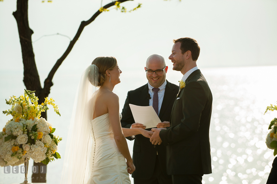 Bride and Groom laughing during the ceremony. Kent Island Maryland Chesapeake Bay Beach Club wedding photo, by wedding photographers of Leo Dj Photography. http://leodjphoto.com