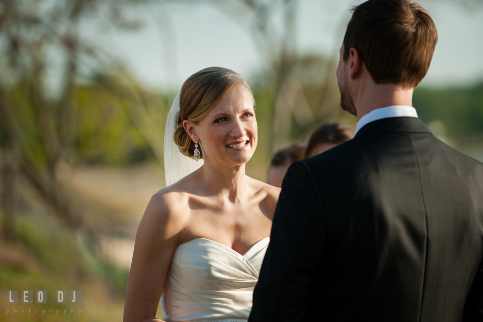 Bride smiling looking at Groom during the vow at the ceremony. Kent Island Maryland Chesapeake Bay Beach Club wedding photo, by wedding photographers of Leo Dj Photography. http://leodjphoto.com