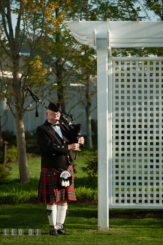 Scottish bagpiper playing bagpipes during the wedding ceremony. Kent Island Maryland Chesapeake Bay Beach Club wedding photo, by wedding photographers of Leo Dj Photography. http://leodjphoto.com