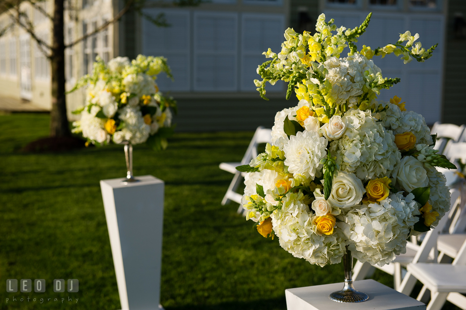 White and yellow floral decorations with roses and hydrangeas by Contessa Flowers florist for the ceremony site. Kent Island Maryland Chesapeake Bay Beach Club wedding photo, by wedding photographers of Leo Dj Photography. http://leodjphoto.com