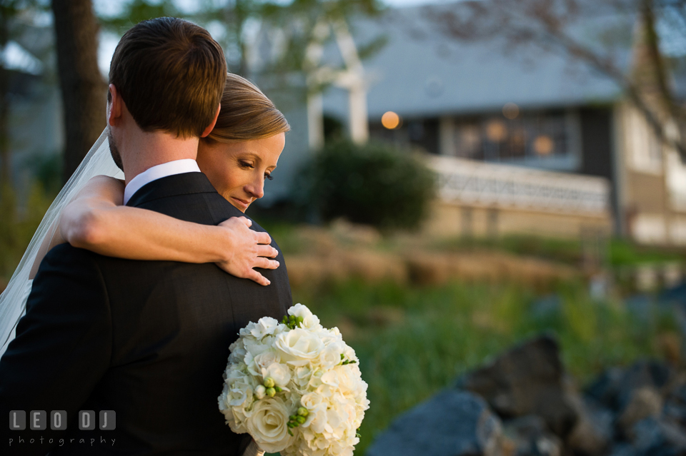 Bride hugging Groom. Kent Island Maryland Chesapeake Bay Beach Club wedding photo, by wedding photographers of Leo Dj Photography. http://leodjphoto.com