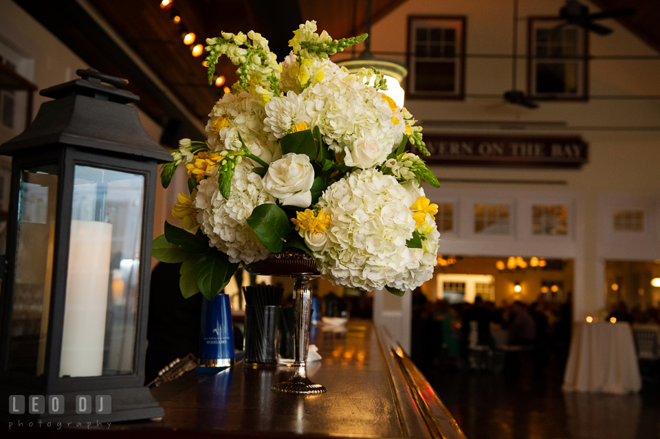 White and yellow floral decorations with roses and hydrangeas on the bar table by Contessa Florwers florist. Kent Island Maryland Chesapeake Bay Beach Club wedding photo, by wedding photographers of Leo Dj Photography. http://leodjphoto.com