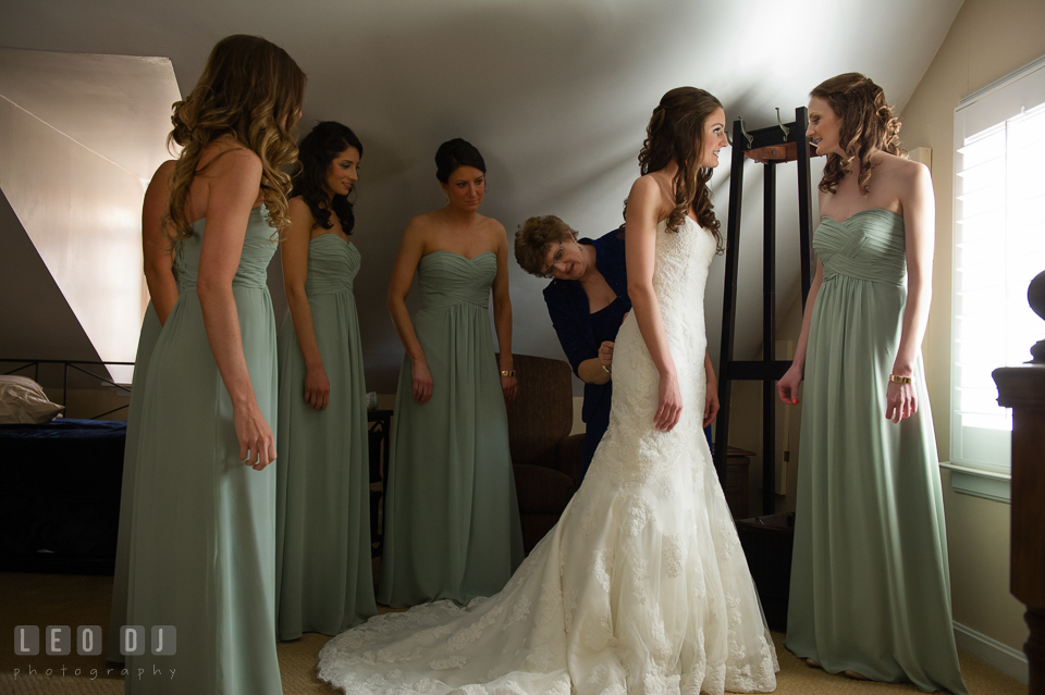 Mother, Maid of Honor and Bridesmaids helping Bride put on and buttoning up her dress. Historic Inns of Annapolis Maryland, Governor Calvert House wedding, by wedding photographers of Leo Dj Photography. http://leodjphoto.com