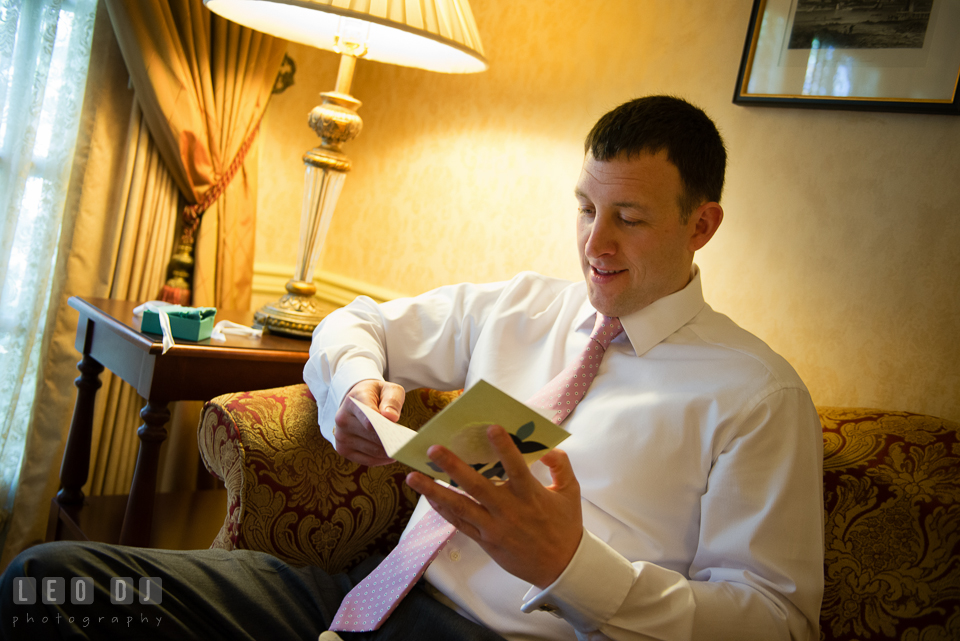 Groom reading card from Bride. Historic Inns of Annapolis Maryland, Governor Calvert House wedding, by wedding photographers of Leo Dj Photography. http://leodjphoto.com