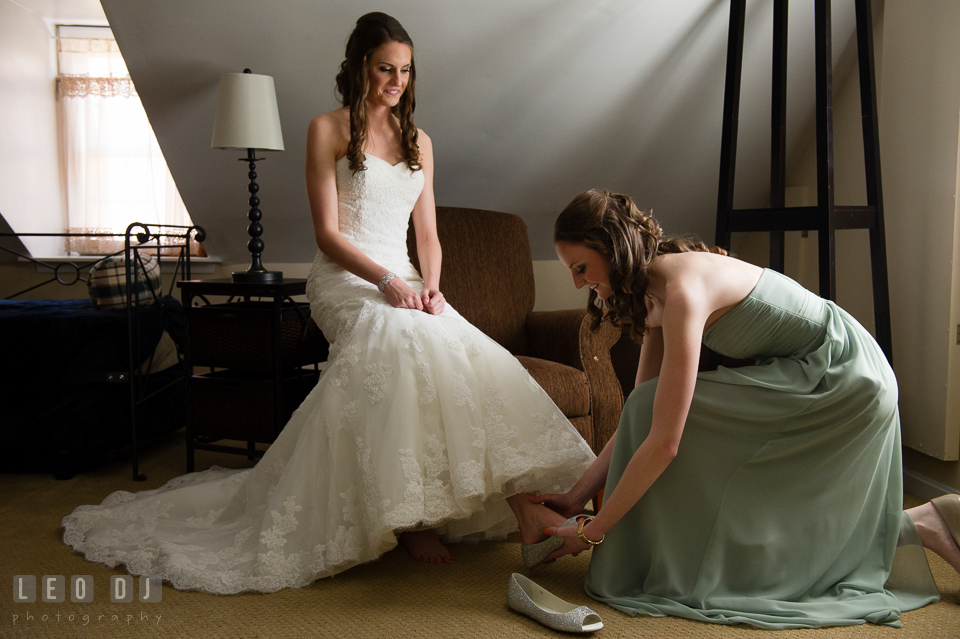 Maid of Honor and sister help Bride put on her shoes. Historic Inns of Annapolis Maryland, Governor Calvert House wedding, by wedding photographers of Leo Dj Photography. http://leodjphoto.com