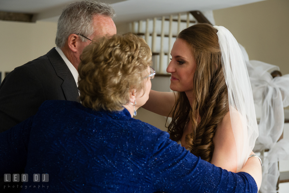 Mother of the Bride hugging her husband and daughter. Historic Inns of Annapolis Maryland, Governor Calvert House wedding, by wedding photographers of Leo Dj Photography. http://leodjphoto.com