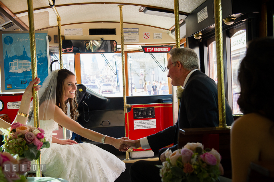 Bride holding her Father's hand in the trolley on their way to the ceremony at the church. Historic Inns of Annapolis Maryland, Governor Calvert House wedding, by wedding photographers of Leo Dj Photography. http://leodjphoto.com