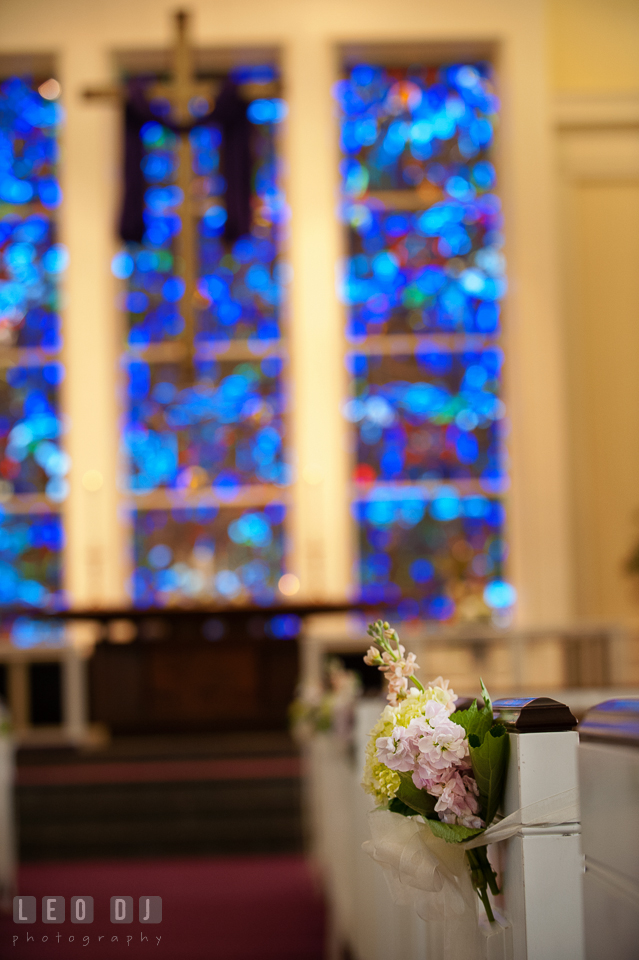 Flower decorations on church pews at Calvary United Methodist Church. Historic Inns of Annapolis Maryland, Governor Calvert House wedding, by wedding photographers of Leo Dj Photography. http://leodjphoto.com