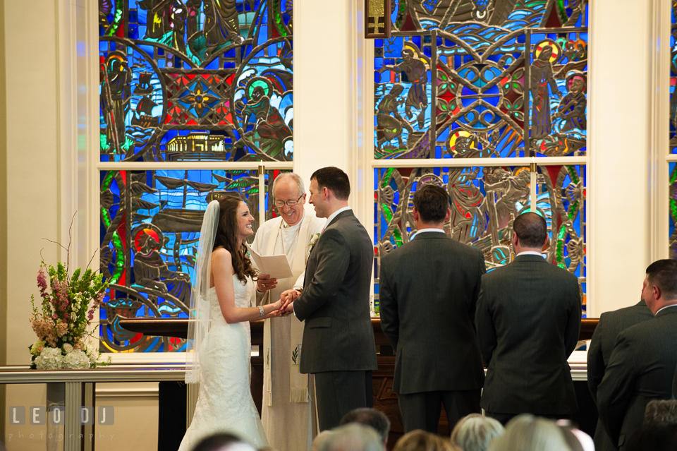 Bride and Groom smiling during their wedding vows at Calvary United Methodist Church. Historic Inns of Annapolis Maryland, Governor Calvert House wedding, by wedding photographers of Leo Dj Photography. http://leodjphoto.com