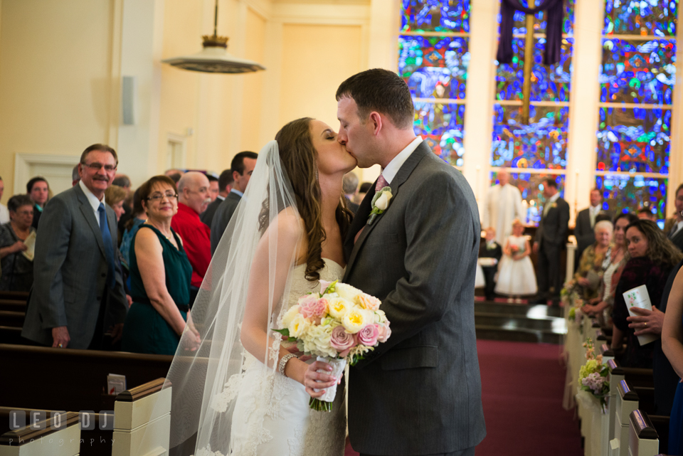 Bride and Groom kissing during ceremony processional at Calvary United Methodist Church. Historic Inns of Annapolis Maryland, Governor Calvert House wedding, by wedding photographers of Leo Dj Photography. http://leodjphoto.com