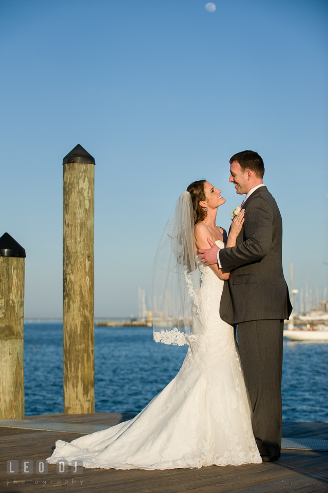 Bride and Groom holding close by the water at the Annapolis dock. Historic Inns of Annapolis Maryland, Governor Calvert House wedding, by wedding photographers of Leo Dj Photography. http://leodjphoto.com