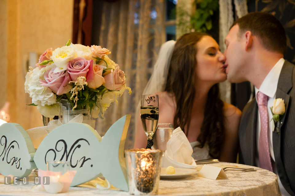 Bride and Groom kissing by the sweetheart table. Historic Inns of Annapolis Maryland, Governor Calvert House wedding, by wedding photographers of Leo Dj Photography. http://leodjphoto.com