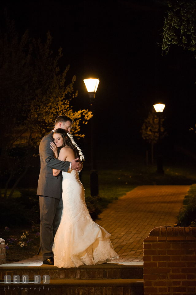 Bride cuddling with Groom outside by the State House. Historic Inns of Annapolis Maryland, Governor Calvert House wedding, by wedding photographers of Leo Dj Photography. http://leodjphoto.com