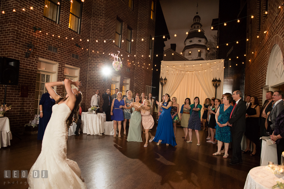 Bride tossed her bouquet toward the single ladies crowd. Historic Inns of Annapolis Maryland, Governor Calvert House wedding, by wedding photographers of Leo Dj Photography. http://leodjphoto.com