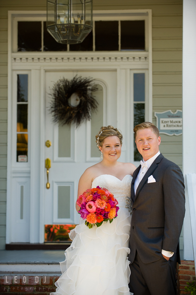 Bride and Groom posing in front of the restaurant entrance. Kent Manor Inn, Kent Island, Eastern Shore Maryland, wedding ceremony and getting ready photos, by wedding photographers of Leo Dj Photography. http://leodjphoto.com