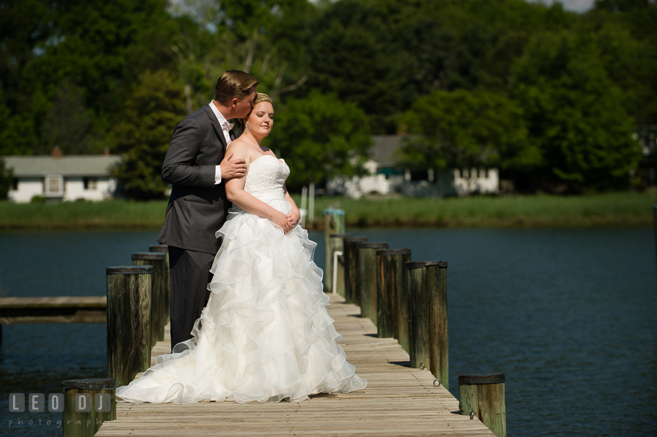 Groom on the dock kissing Bride's temple. Kent Manor Inn, Kent Island, Eastern Shore Maryland, wedding ceremony and getting ready photos, by wedding photographers of Leo Dj Photography. http://leodjphoto.com