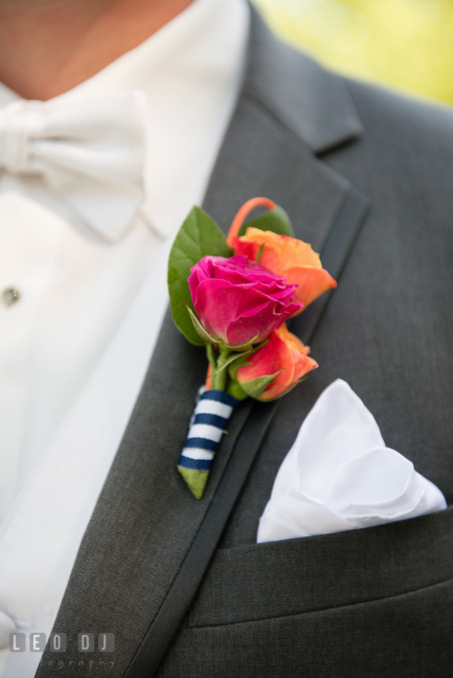 Groom's boutonniere using dark pink and orange roses. Kent Manor Inn, Kent Island, Eastern Shore Maryland, wedding ceremony and getting ready photos, by wedding photographers of Leo Dj Photography. http://leodjphoto.com